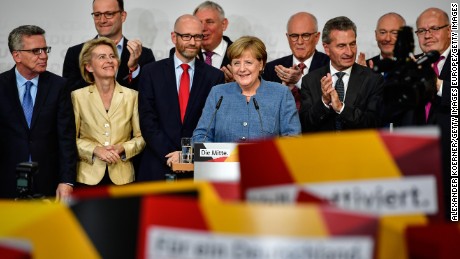BERLIN, GERMANY - SEPTEMBER 24: German Chancellor and Christian Democrat (CDU) Angela Merkel (C) reacts to initial results that give the party 32,9% of the vote, giving it a first place finish, in German federal elections on September 24, 2017 in Berlin, Germany. Chancellor Merkel is seeking a fourth term and coming weeks will likely be dominated by negotiations between parties over the next coalition government. (Photo by Alexander Koerner/Getty Images)