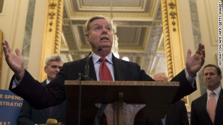 Senator Lindsey Graham (C), R-SC, stands with Senator Bill Cassidy, R-LA, Senator Dean Heller (L), and Senator Ron Johnson, R-WI, as well as former Senator Rick Santorum (R), to announce their legislation to repeal and replace Obamacare through block grants on Capitol Hill in Washington, DC, on September 13, 2017.   / AFP PHOTO / JIM WATSON        (Photo credit should read JIM WATSON/AFP/Getty Images)