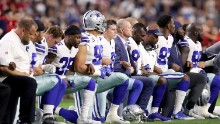 GLENDALE, AZ - SEPTEMBER 25: Members of the Dallas Cowboys link arms and kneel during the National Anthem before the start of the NFL game against the Arizona Cardinals at the University of Phoenix Stadium on September 25, 2017 in Glendale, Arizona. (Photo by Christian Petersen/Getty Images)