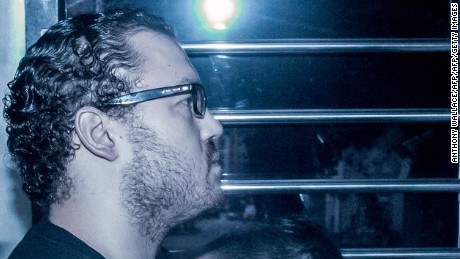 British banker Rurik Jutting accused of the murders of two Indonesian women, sits in a prison van as he arrives at the eastern court in Hong Kong on May 8, 2015. Jutting on May 8 returned to court for a hearing. AFP PHOTO / ANTHONY WALLACE        (Photo credit should read ANTHONY WALLACE/AFP/Getty Images)