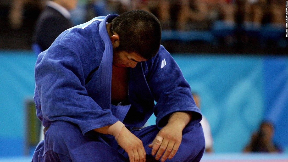 Inoue sits dejected after a loss to Dutch opponent Elco van Der Geest in men&#39;s -100 kg competition at the Athens 2004 Olympic Games.