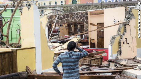 A survivor contemplates property damage in San Juan, Puerto Rico, after Hurricane Maria.