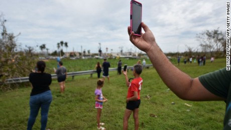 People try to get a cellphone signal in Dorado, 40 km north of San Juan, Puerto Rico, on September 23. Communications, electric power, water supply and the lack of gas have been seriously affected after the passage of Hurricane Maria.