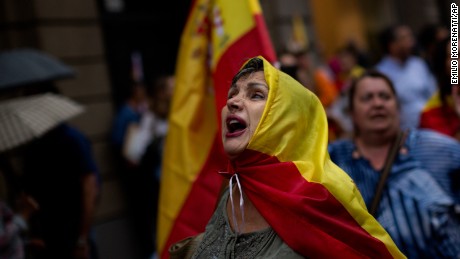 Anti-independence demonstrators march waving Spanish flags against the referendum downtown Barcelona on September 30. The planned referendum is due to be held Sunday by the pro-independence Catalan government but Spain&#39;s government calls the vote illegal, since it violates the constitution, and the country&#39;s Constitutional Court has ordered it suspended. 