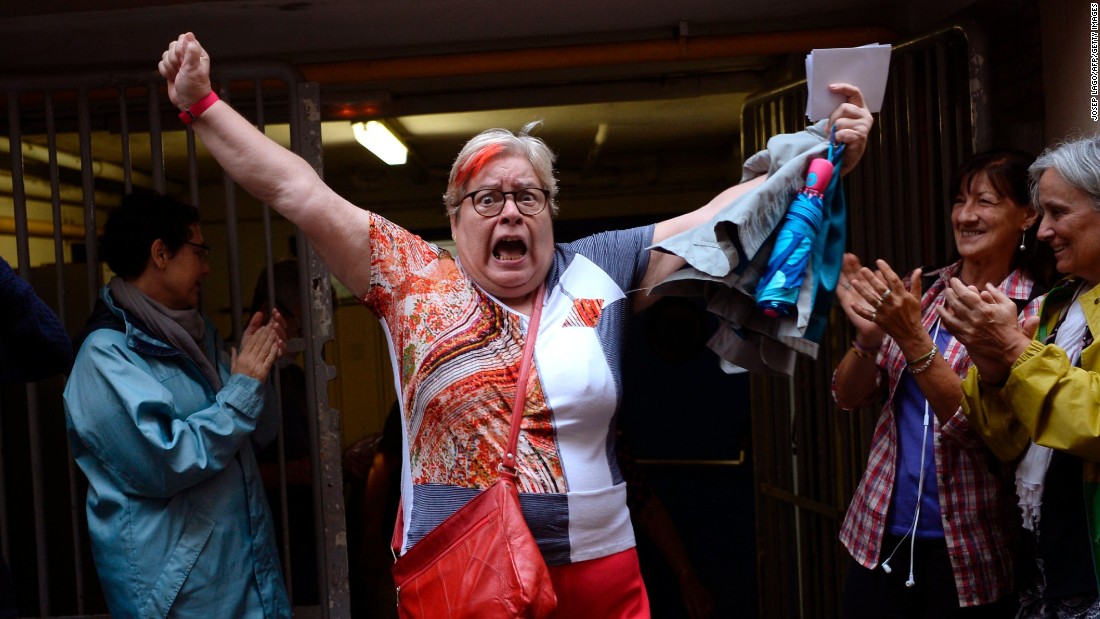 A woman celebrates outside a polling station after casting her vote in Barcelona, on October 01 in a referendum on independence for Catalonia.