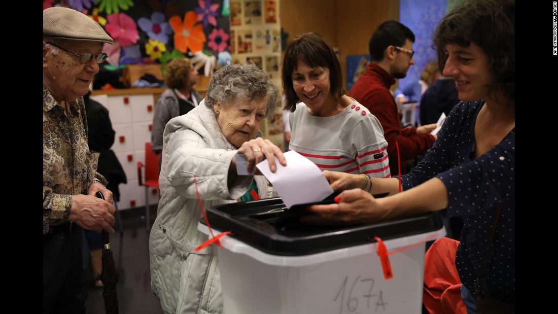 A woman casts her vote at a polling station in Barcelona.