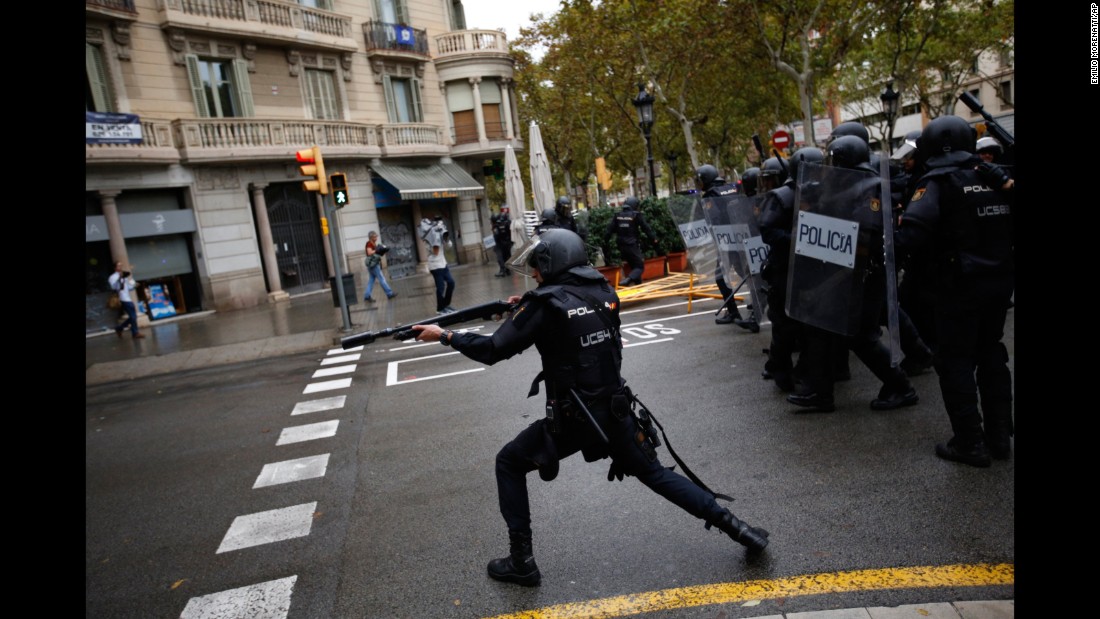 Spanish riot police shoot rubber bullets at people trying to reach a voting site designated by the Catalan government in Barcelona. The deputy mayor of Barcelona said police fired rubber bullets at people as they attempted to vote in the referendum, which Spain&#39;s top court has declared illegal. There were reports that police in Girona, Spain, used batons.