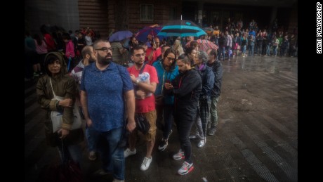 People queue to vote in the banned referendum on Catalonia&#39;s independence.