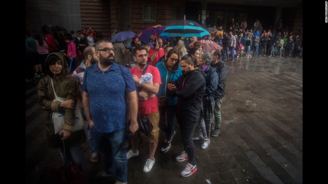People queue to vote at a school in Barcelona.