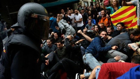 Spanish National Police clash with pro-independence supporters in Barcelona on October 1.