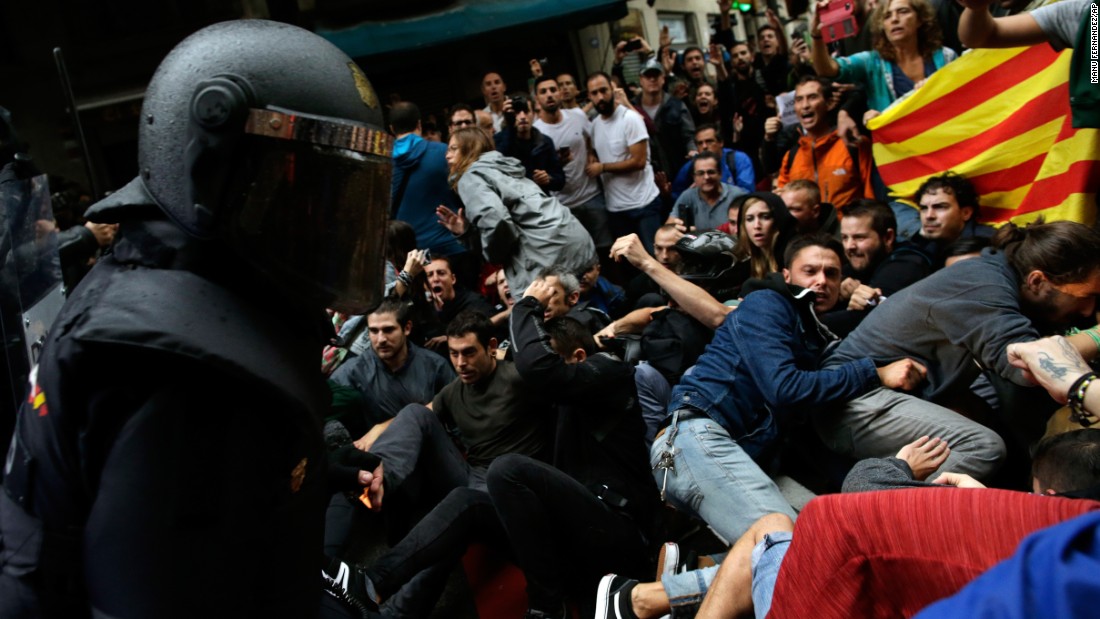 Spanish National Police clash with pro-referendum supporters in Barcelona.