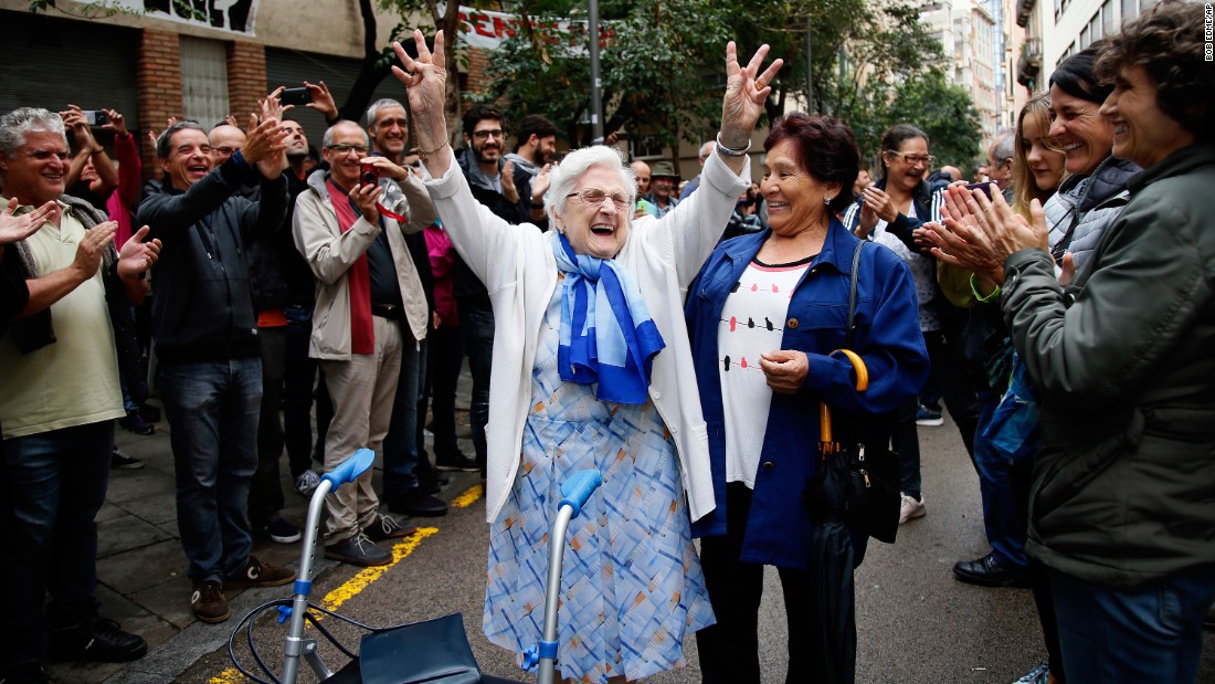 A woman celebrates after voting at a polling station in Barcelona on October 1.