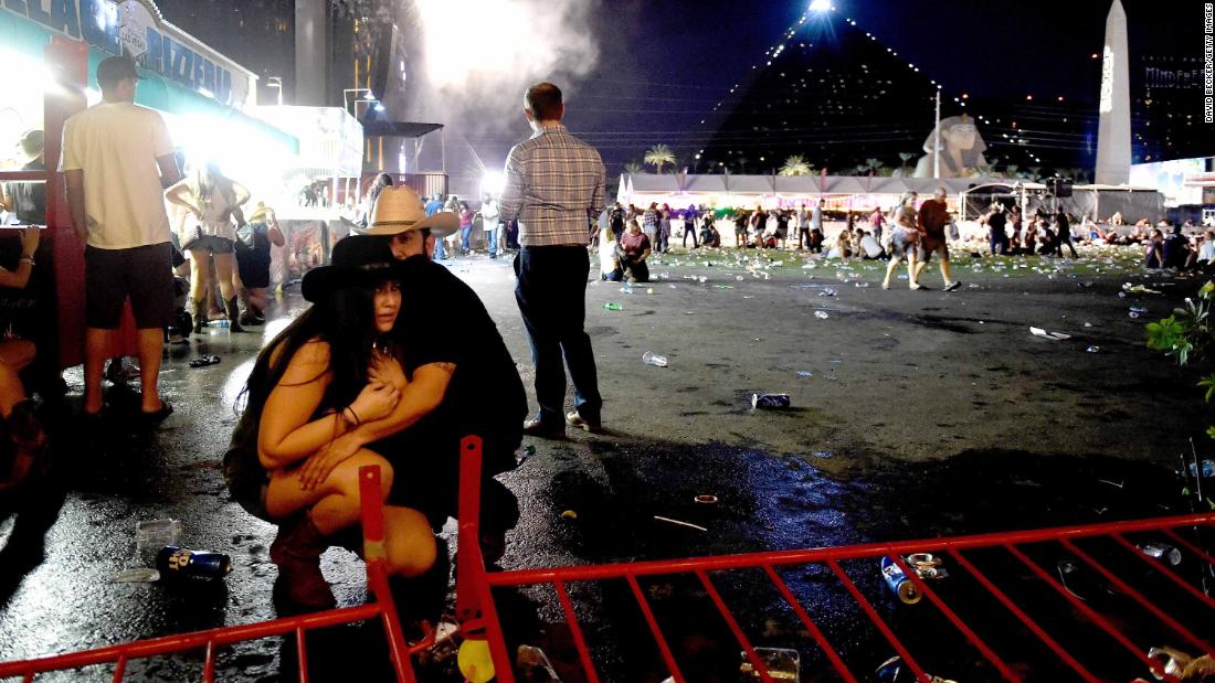 A couple huddles after shots rang out at a country music festival on the Las Vegas Strip on Sunday, October 1, 2017. At least 58 people were killed and almost 500 were injured when &lt;a href=&quot;http://www.cnn.com/2017/10/02/us/las-vegas-shooter/index.html&quot; target=&quot;_blank&quot;&gt;a gunman opened fire&lt;/a&gt; on the crowd. Police said the gunman, 64-year-old Stephen Paddock, fired from the Mandalay Bay hotel, several hundred feet southwest of the concert grounds. He was found dead in his hotel room, and authorities believe he killed himself and that he acted alone. It is the deadliest mass shooting in modern US history.