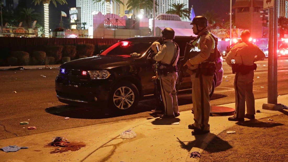 Police stand at the scene of the shooting.