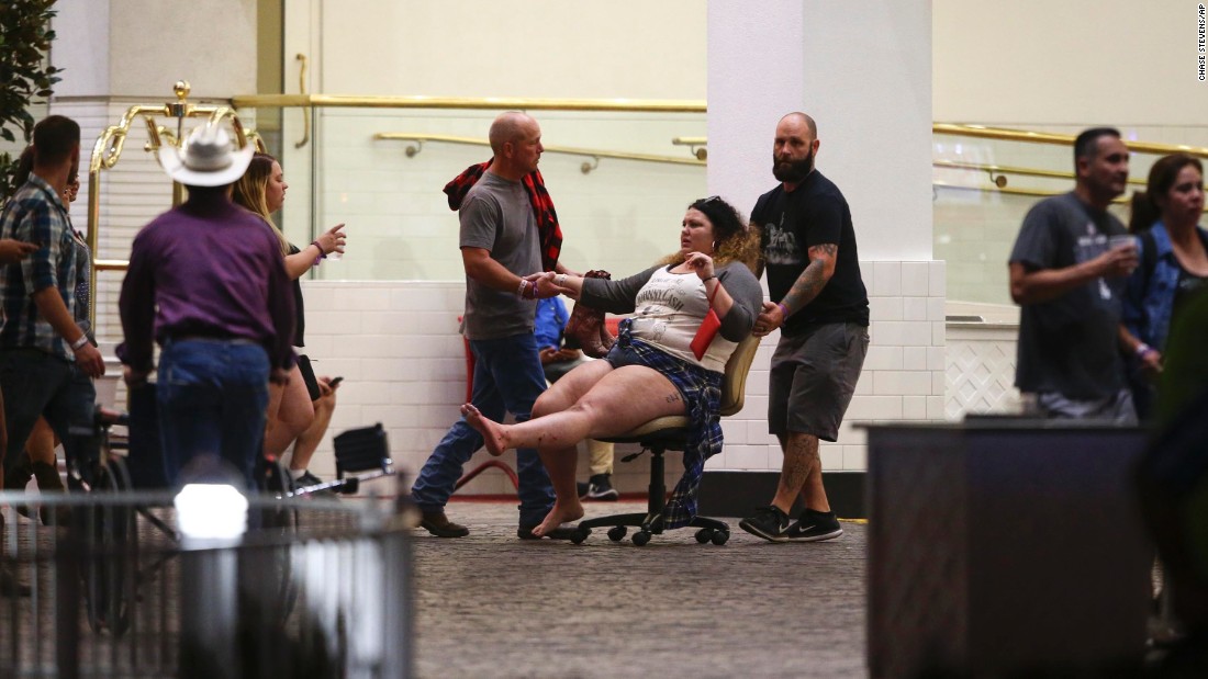 A woman is moved outside the Las Vegas Tropicana resort. Multiple victims were being transported to hospitals in the aftermath of the shooting. 