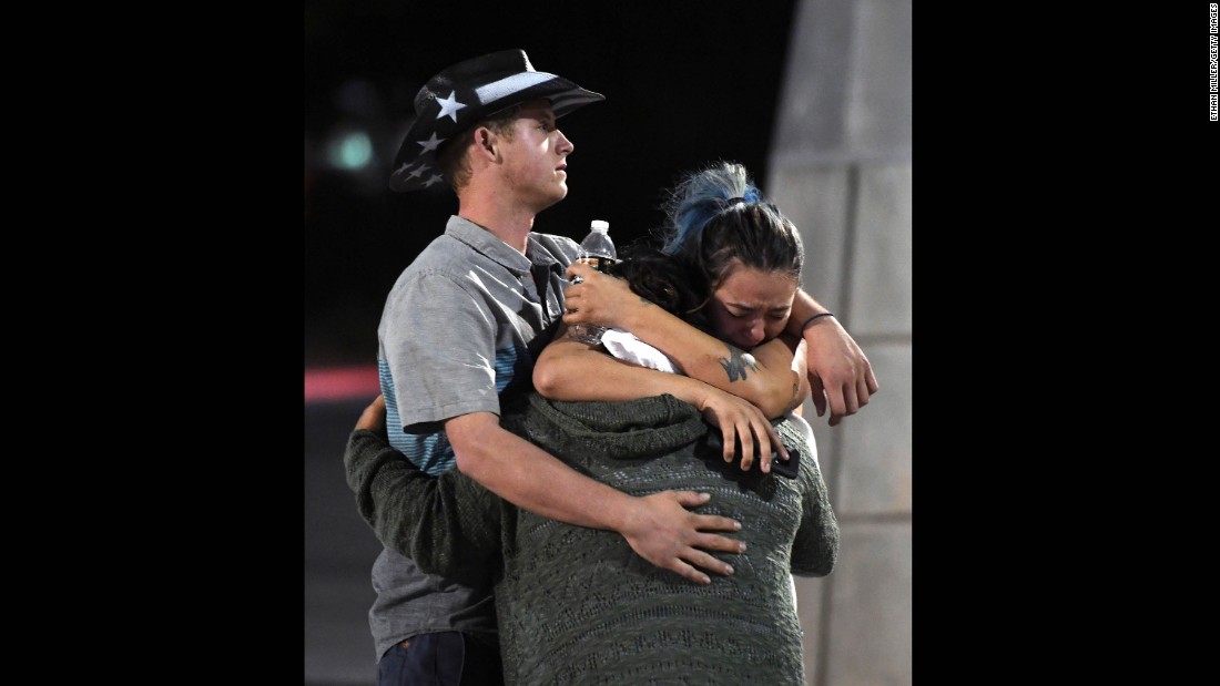 People embrace outside the Thomas &amp;amp; Mack Center after the shooting. 