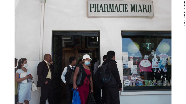 People queue at a pharmacy in downtown Antananarivo, Madagascar to buy protection masks against infections and medicines against plague on Monday, October 2.