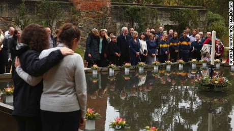 Family and community members lay 35 floral tributes at a memorial pool to Port Arthur victims during the 20th anniversary commemoration service in 2016. 