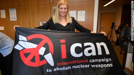 Nuclear disarmament group ICAN executive director Beatrice Fihn holds a banner with their logo after ICAN won the Nobel Peace Prize.