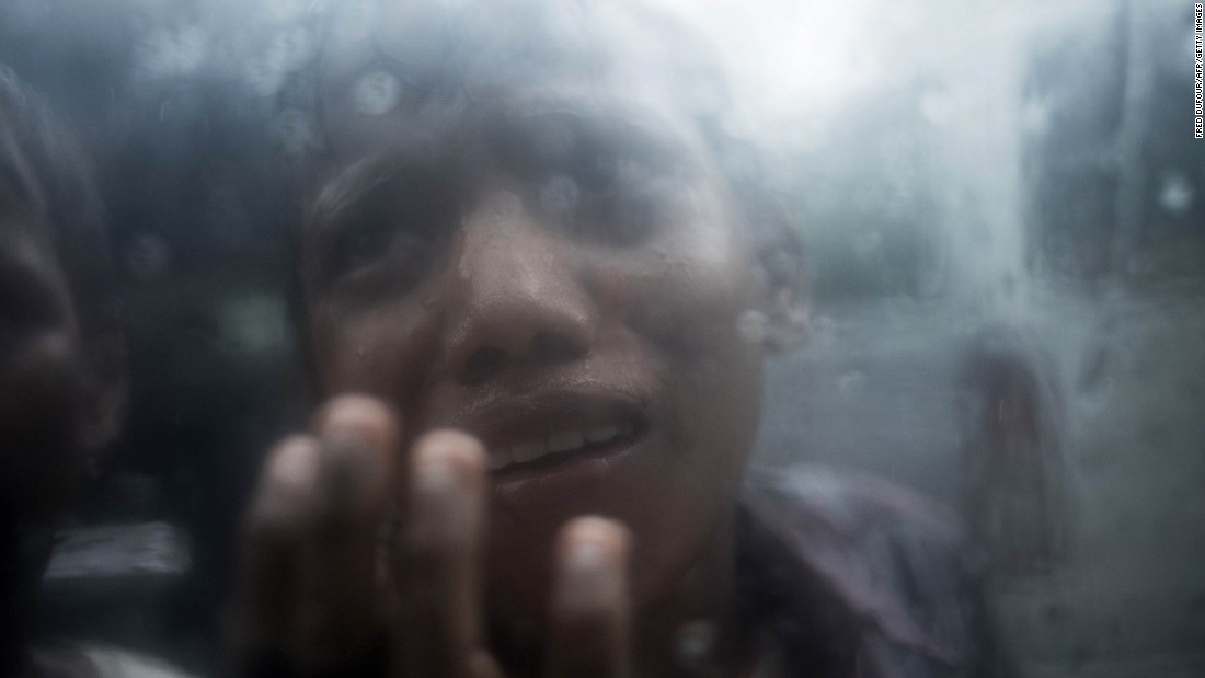 A young Rohingya refugee begs for food through the glass of a car window at Balukhali refugee camp in Bangladesh on October 7.