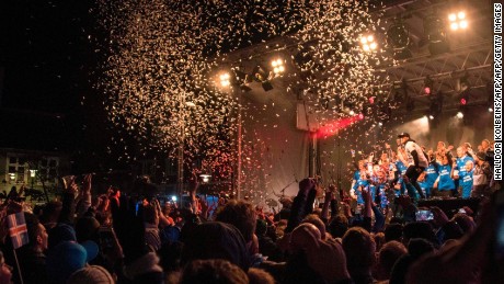 Iceland's national team football players and coaching staff celebrate with fans at Ingolfstorg square in the centre of Reykjavik after the FIFA World Cup 2018 qualification football match against Kosovo in Reykjavik, Iceland on October 9, 2017.
Iceland qualified for the FIFA World Cup 2018 as smallest country ever after beating Kosovo 2-0 at home in Reykjavik. / AFP PHOTO / Halldor KOLBEINS        (Photo credit should read HALLDOR KOLBEINS/AFP/Getty Images)