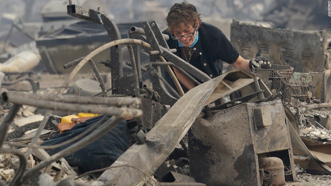 Kristine Pond searches what&#39;s left of her family&#39;s home in Santa Rosa on October 9.