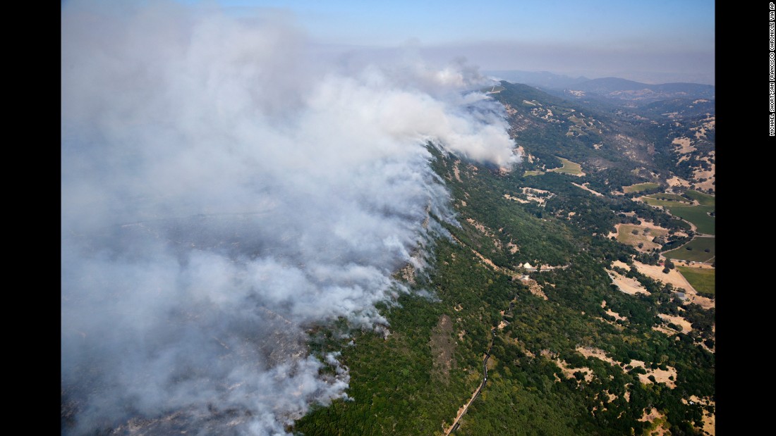 Smoke rises in the hills east of Napa on October 9.