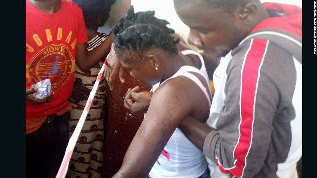 A female voter is held up after fainting in line at the School of Christ polling center in Weala, Margibi County. She had been waiting to vote since 5am in the morning. &lt;br /&gt;&lt;br /&gt;Credit: Local Voices Liberia/Emmanuel Tophic Degleh