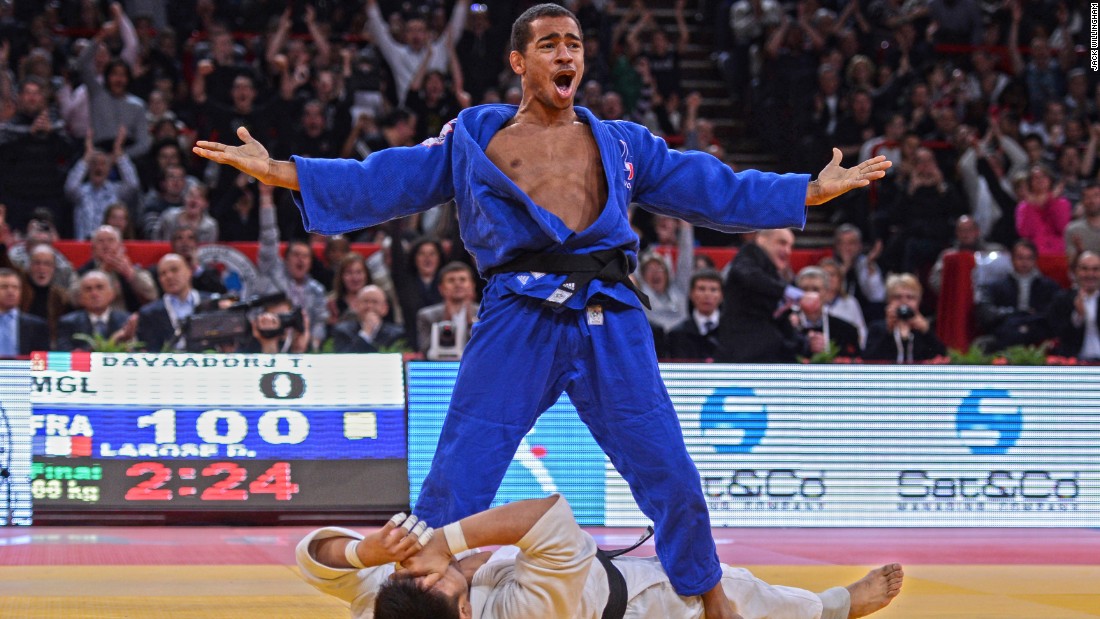 This image is in because I love working in Paris. The iconic Bercy Stadium (as it was called then) has the best public, atmosphere and energy of any tournament in the world. This picture is France&#39;s David Larose celebrating after winning the Paris Grand Slam in 2013. I love the story it tells: Larose ecstatic standing over a distraught Davaadorj Tumurkhuleg, the scoreboard reading ippon and the crowd going mad.