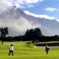 Workers clean grass at Merapi golf driving range as Merapi volcano spews hot smoke extreme golf 