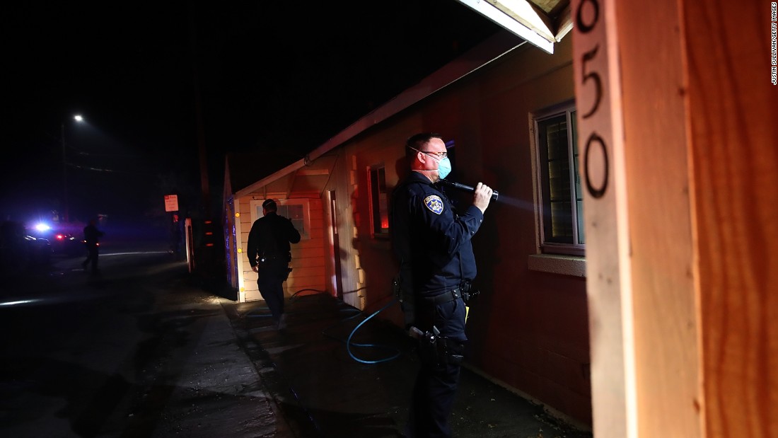 Highway Patrol officers go door to door to ask Sonoma residents to evacuate their homes as a wildfire approaches on October 11.