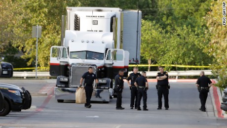 San Antonio police officers investigate the scene last July after 39 immigrants were found.