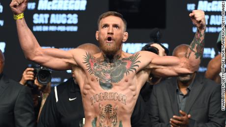 LAS VEGAS, NV - AUGUST 25:  UFC lightweight champion Conor McGregor poses on the scale during his official weigh-in at T-Mobile Arena on August 25, 2017 in Las Vegas, Nevada. McGregor will meet boxer Floyd Mayweather Jr. in a super welterweight boxing match at T-Mobile Arena on August 26.  (Photo by Ethan Miller/Getty Images)