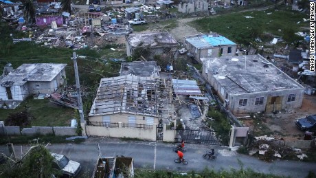 SAN ISIDRO, PUERTO RICO - OCTOBER 05:  Kids bike in an area without grid power or running water about two weeks after Hurricane Maria swept through the island on October 5, 2017 in San Isidro, Puerto Rico. Puerto Rico experienced widespread damage including most of the electrical, gas and water grid as well as agriculture after Hurricane Maria, a category 4 hurricane, swept through.  (Photo by Mario Tama/Getty Images)