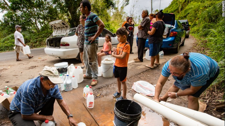 Without running water at home, many people resorted to collecting supplies from mountain springs and streams, as here in Las Marias last October.