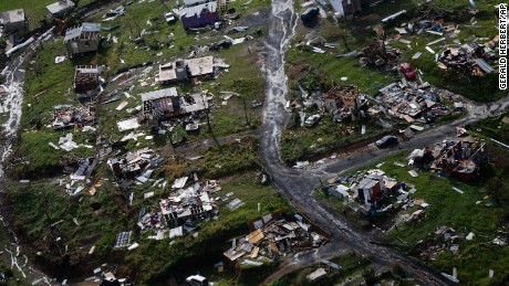 Destroyed communities are seen in the aftermath of Hurricane Maria in Toa Alta, Puerto Rico, Thursday, Sept. 28, 2017. The aftermath of the powerful storm has resulted in a near-total shutdown of the U.S. territory&#39;s economy that could last for weeks and has many people running seriously low on cash and worrying that it will become even harder to survive on this storm-ravaged island. (AP Photo/Gerald Herbert)