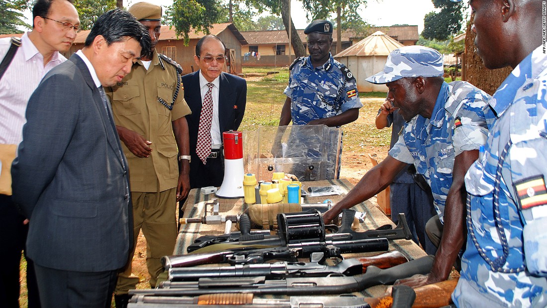 North Korean vice Minister of the the Ministry of Peoples Security, Mr. Ri Song Chol (second from the left) inspects weapons at a police training academy in Kampala, Uganda, in June 2013. 