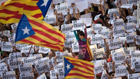 Protesters hold signs reading &quot;Freedom for the two Jordis&quot; on Saturday, referring to two jailed Catalan activists.