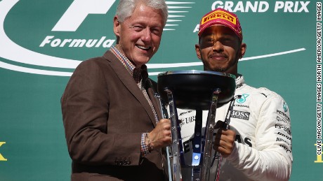 AUSTIN, TX - OCTOBER 22:  Race winner Lewis Hamilton of Great Britain and Mercedes GP is presented with the winners trophy by former President of the USA Bill Clinton during the United States Formula One Grand Prix at Circuit of The Americas on October 22, 2017 in Austin, Texas.  (Photo by Clive Mason/Getty Images)