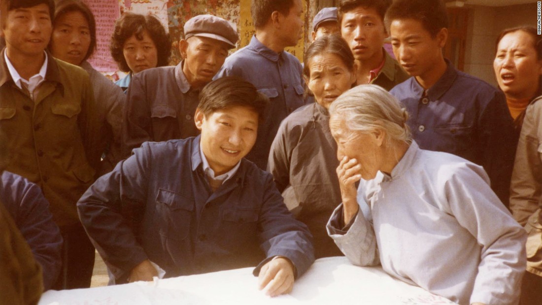 Xi listens to villagers in north China&#39;s Zhengding County in 1983. At the time, he was secretary of the Zhengding County Committee.