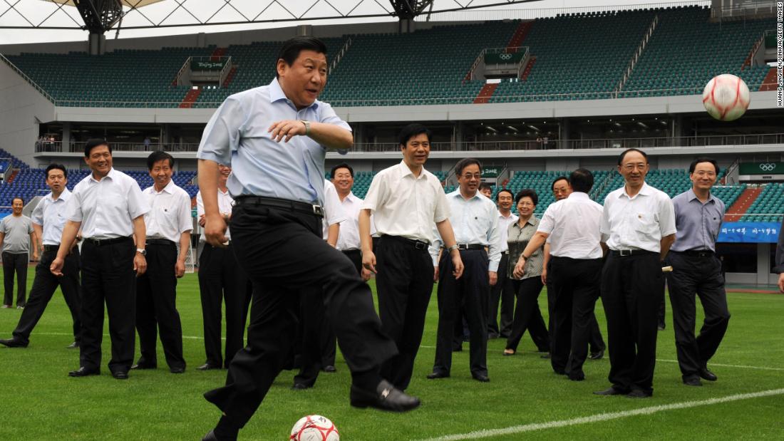 Xi kicks a soccer ball in 2008 as he inspects a field in Qinhuangdao, China. The stadium was hosting games during the 2008 Summer Olympics.