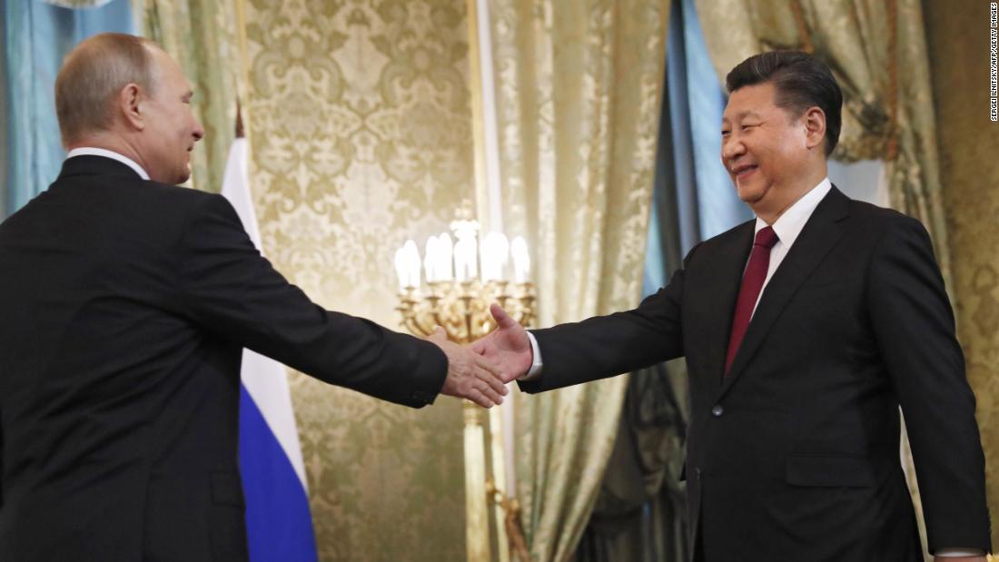 Xi shakes hands with Russian President Vladimir Putin before a meeting in Moscow in July 2017.