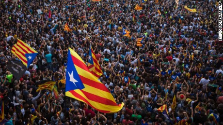 People wave "estelada" or pro independence flags outside the Palau Generalitat in Barcelona, Spain, after Catalonia's regional parliament passed a motion with which they say they are establishing an independent Catalan Republic, Friday, Oct. 27, 2017. (AP Photo/Emilio Morenatti)