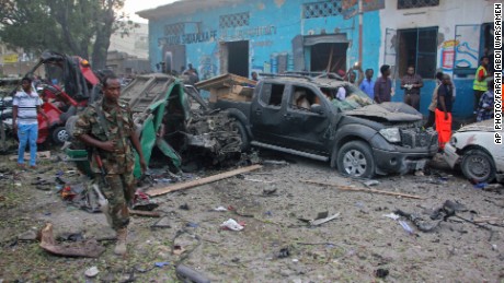 A Somali soldier is shown near wreckage from a car bomb detonated in Mogadishu, Somalia, on Saturday. 