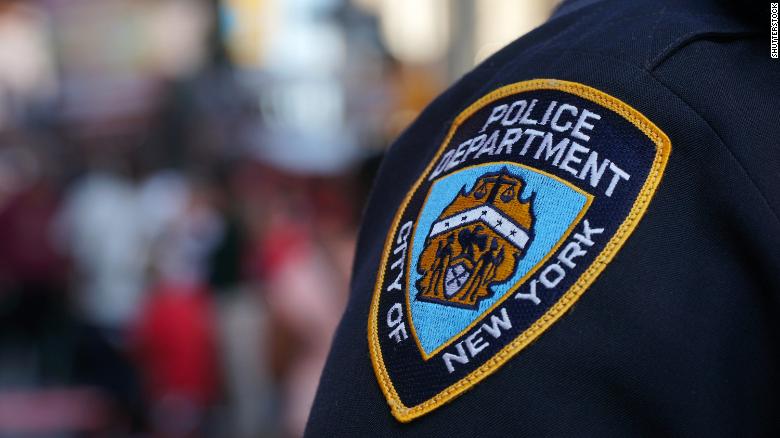 An NYPD official is under investigation after a report connects him to racist posts on police message board