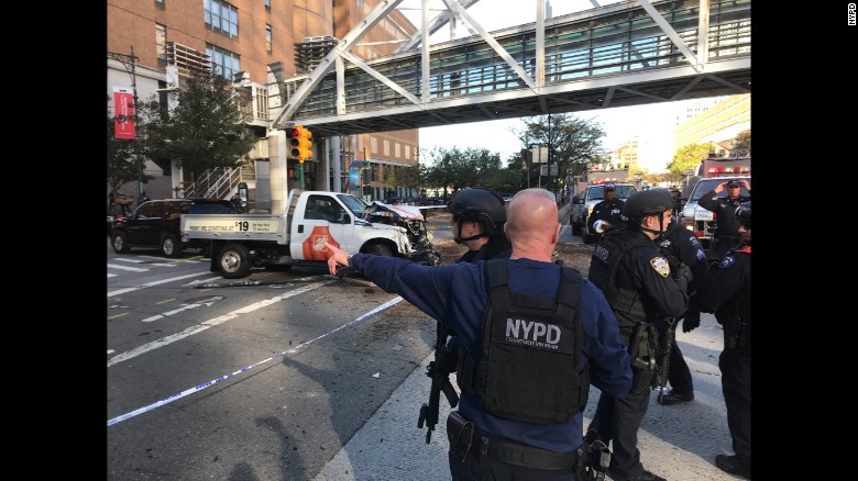 New York City police work in Manhattan after a rental truck drove down a busy bicycle path and struck people on Tuesday, October 31. At least eight people were killed and nearly a dozen were injured in the incident, which is being investigated as terrorism, according to multiple law enforcement sources. A suspect is in custody.