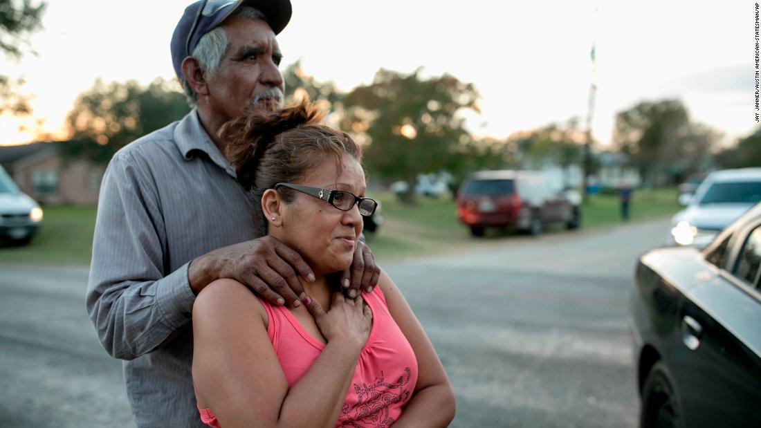 Enrique and Gabby Garcia watch investigators at the scene. 