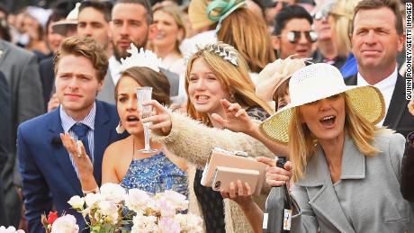 Fans cheer on the horses during Melbourne Cup Day at Flemington Racecourse in 2017.