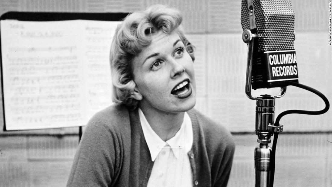 Day became a performer on local radio and then joined a swing band. The bandleader feared that her last name was too long for a marquee, so he dubbed her Doris Day after a song of hers, &quot;Day After Day.&quot; In 1947, she signed a contract with Columbia Records.