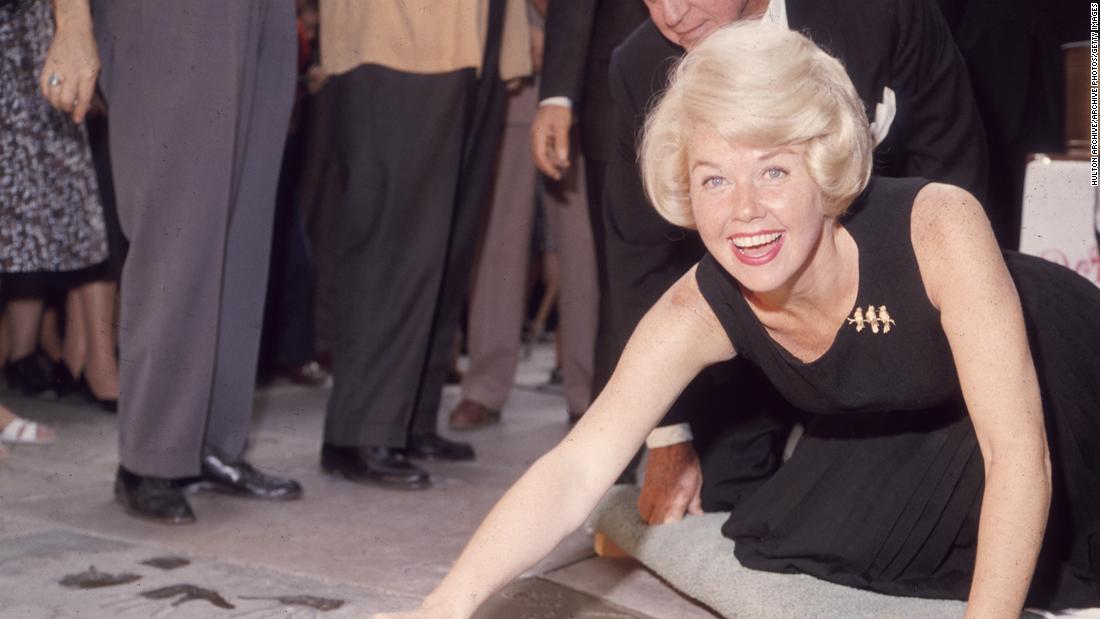 Day signs her name in wet cement next to her handprints in Hollywood. In 1960, Day received two stars on the Hollywood Walk of Fame: one for music and one for film.